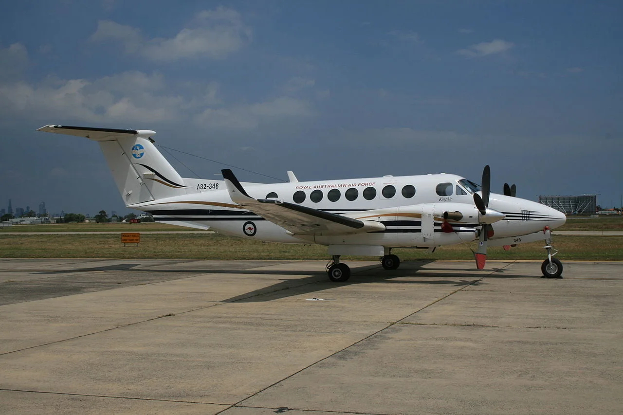 King Air B 200 twin-turboprop aircraft parked on the runway, showcasing its sleek design available for air charter service